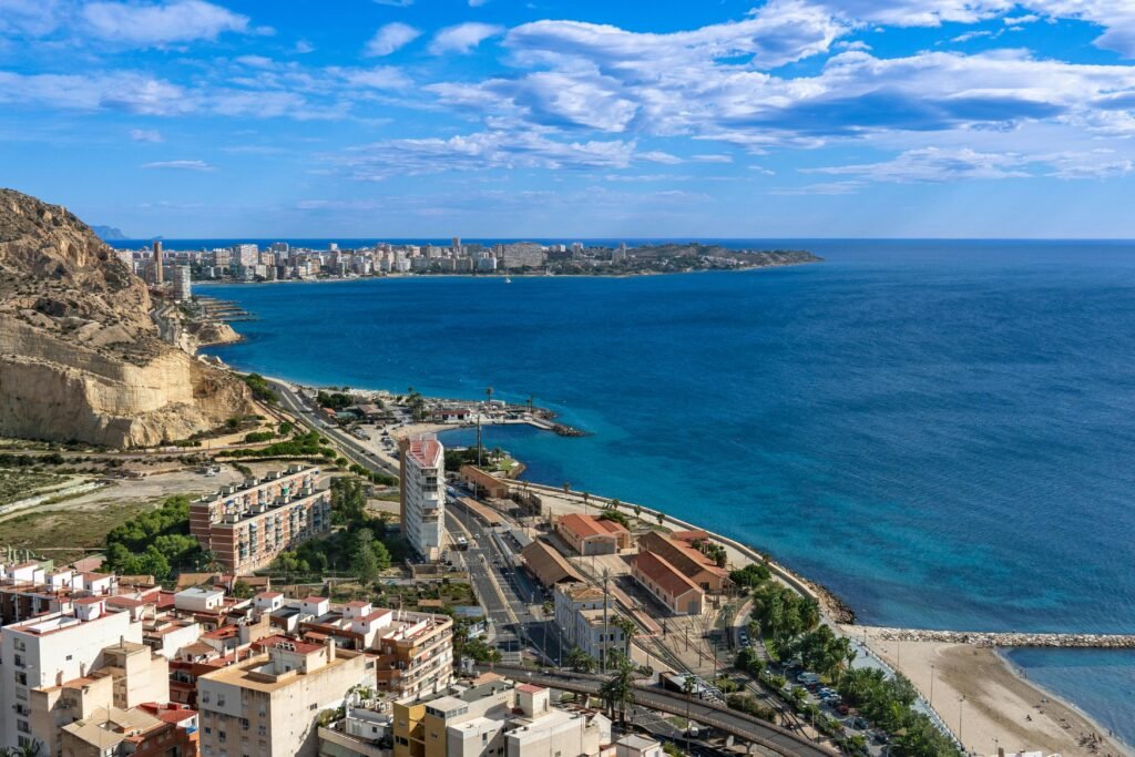 Spectacular aerial view of Alicante's coastline, highlighting azure waters and scenic cityscape.